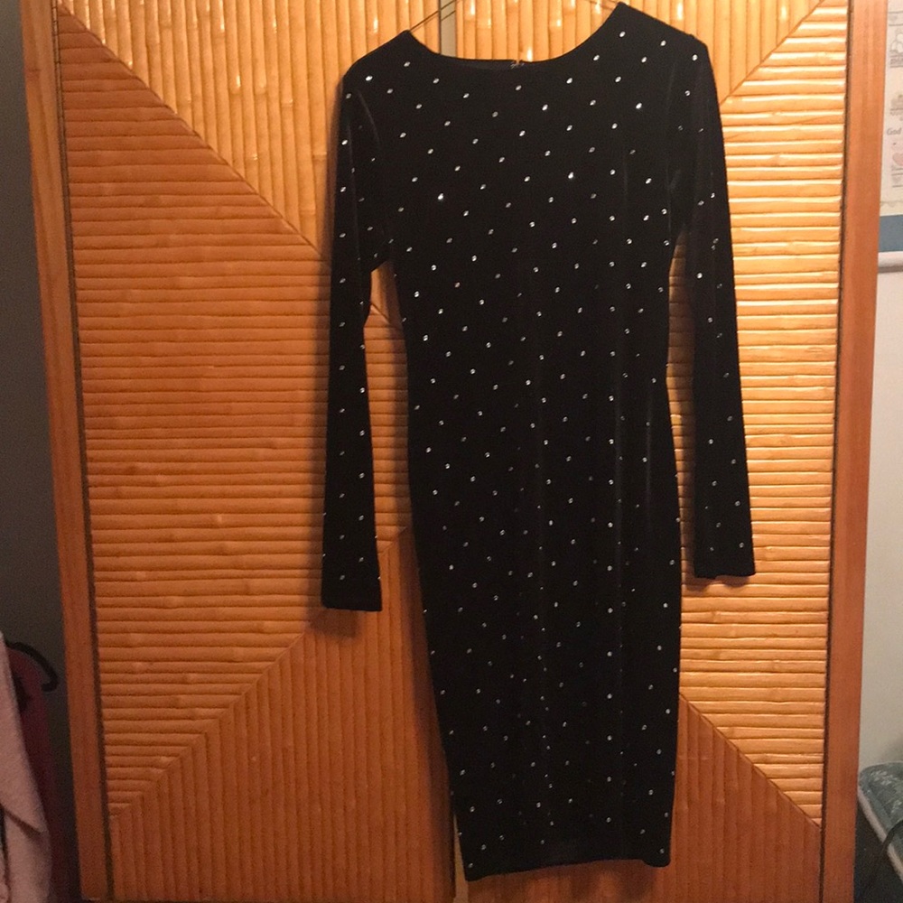 A long sleeve black velvet dress